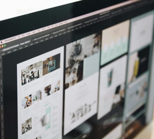 A modern computer screen displaying web design work, showcasing creative visuals in a workspace.