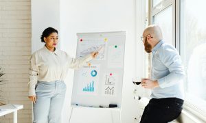 Colleagues engaged in a finance presentation analyzing growth charts and data insights.